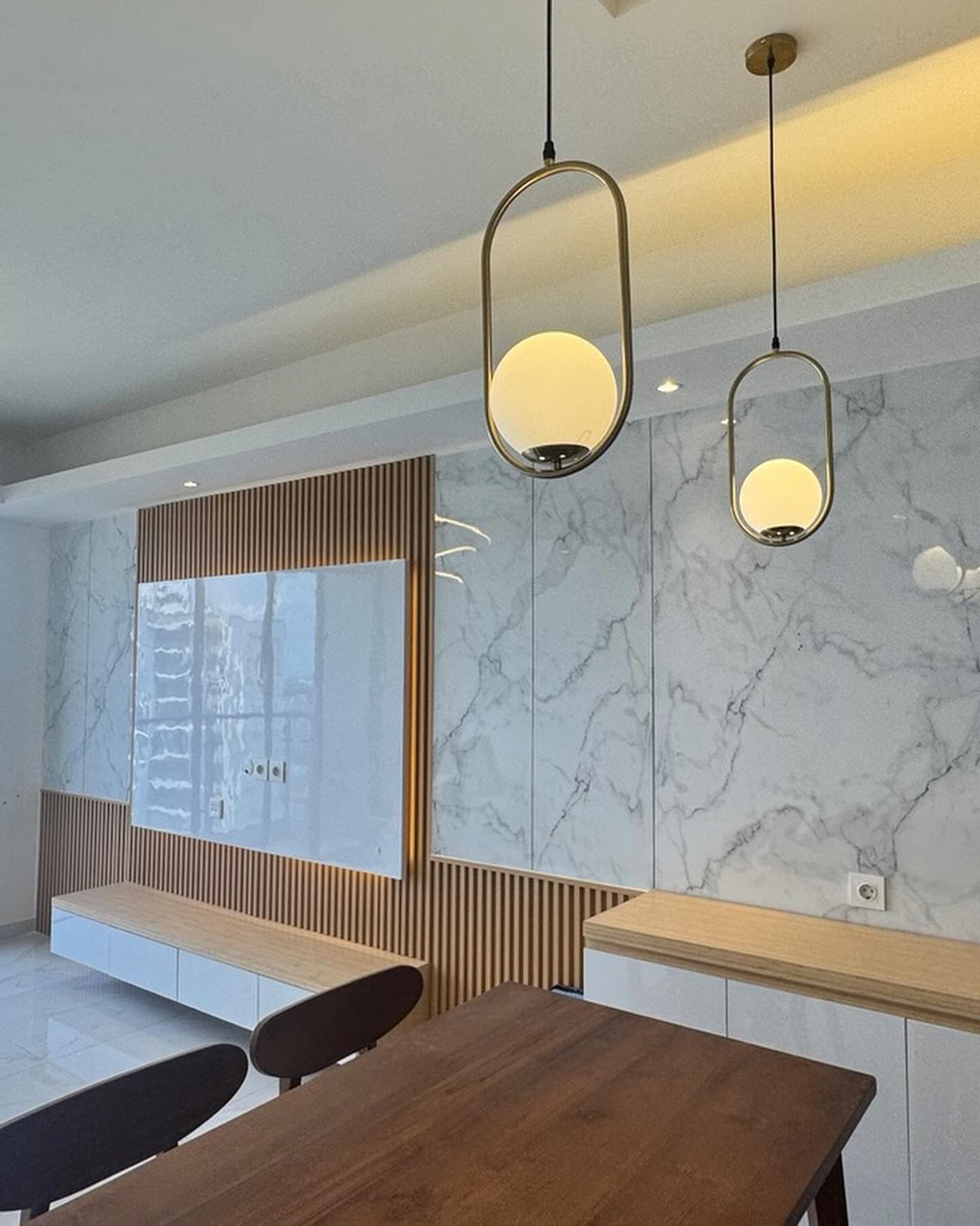 Site photo of the dining area with marble panels and timber slats
