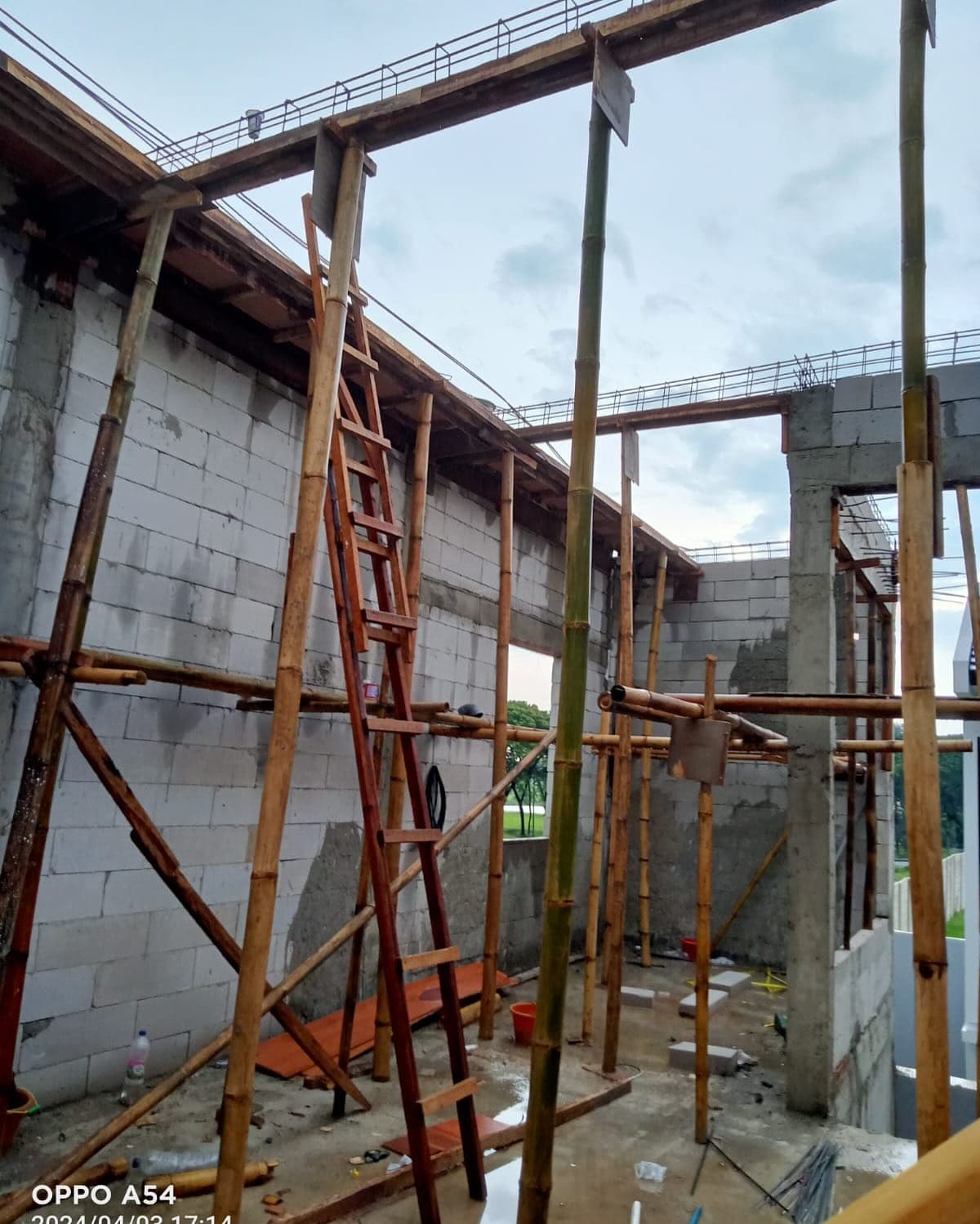 Structure in progress with ladder, scaffolding, and blocks