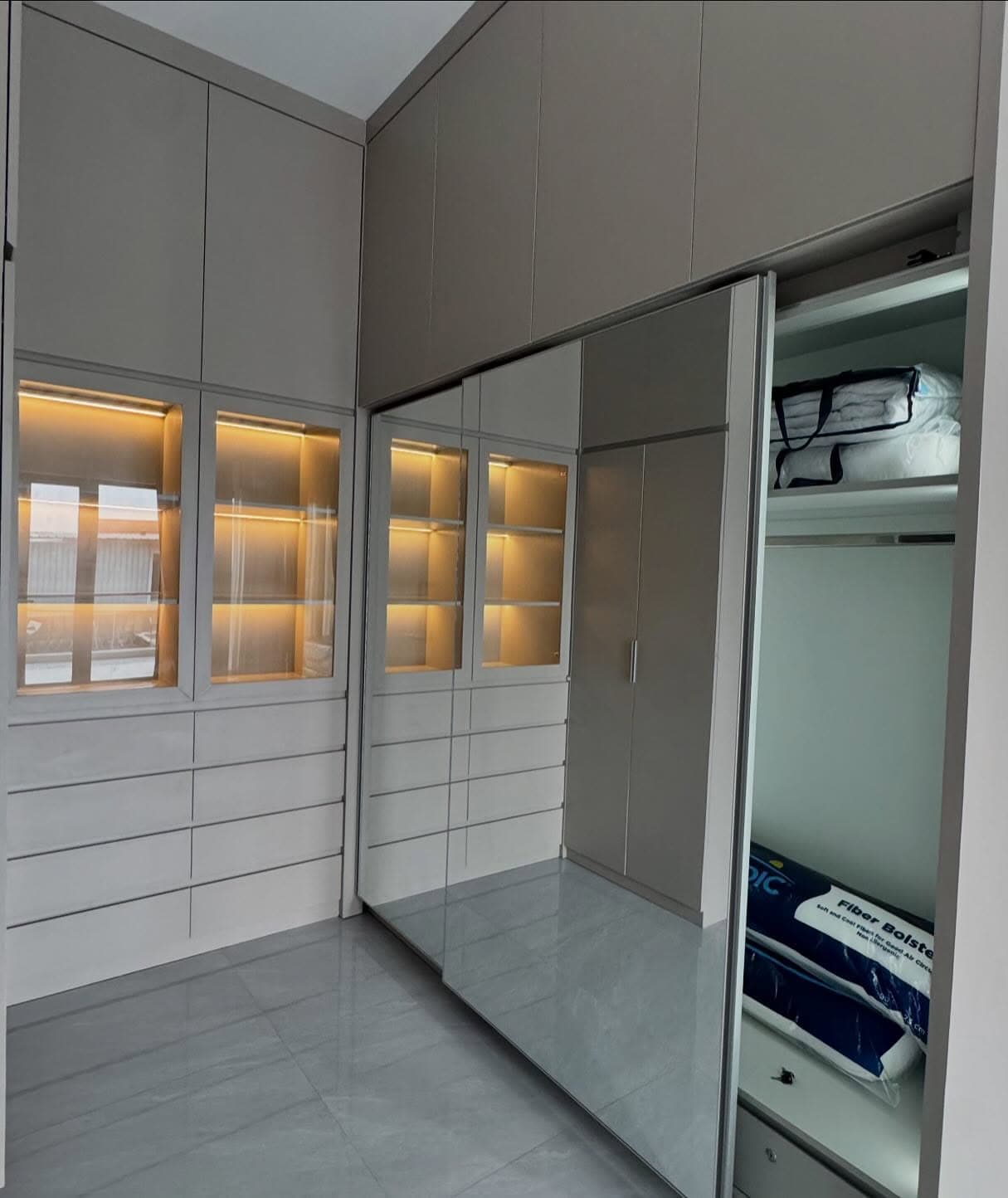 Wardrobe with lit display cabinets, photographed on site