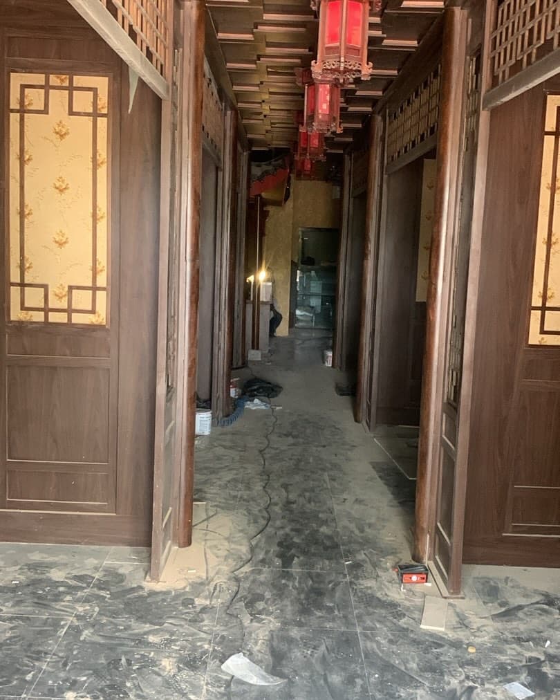 Restaurant corridor with timber door frames and hanging lanterns during fit-out