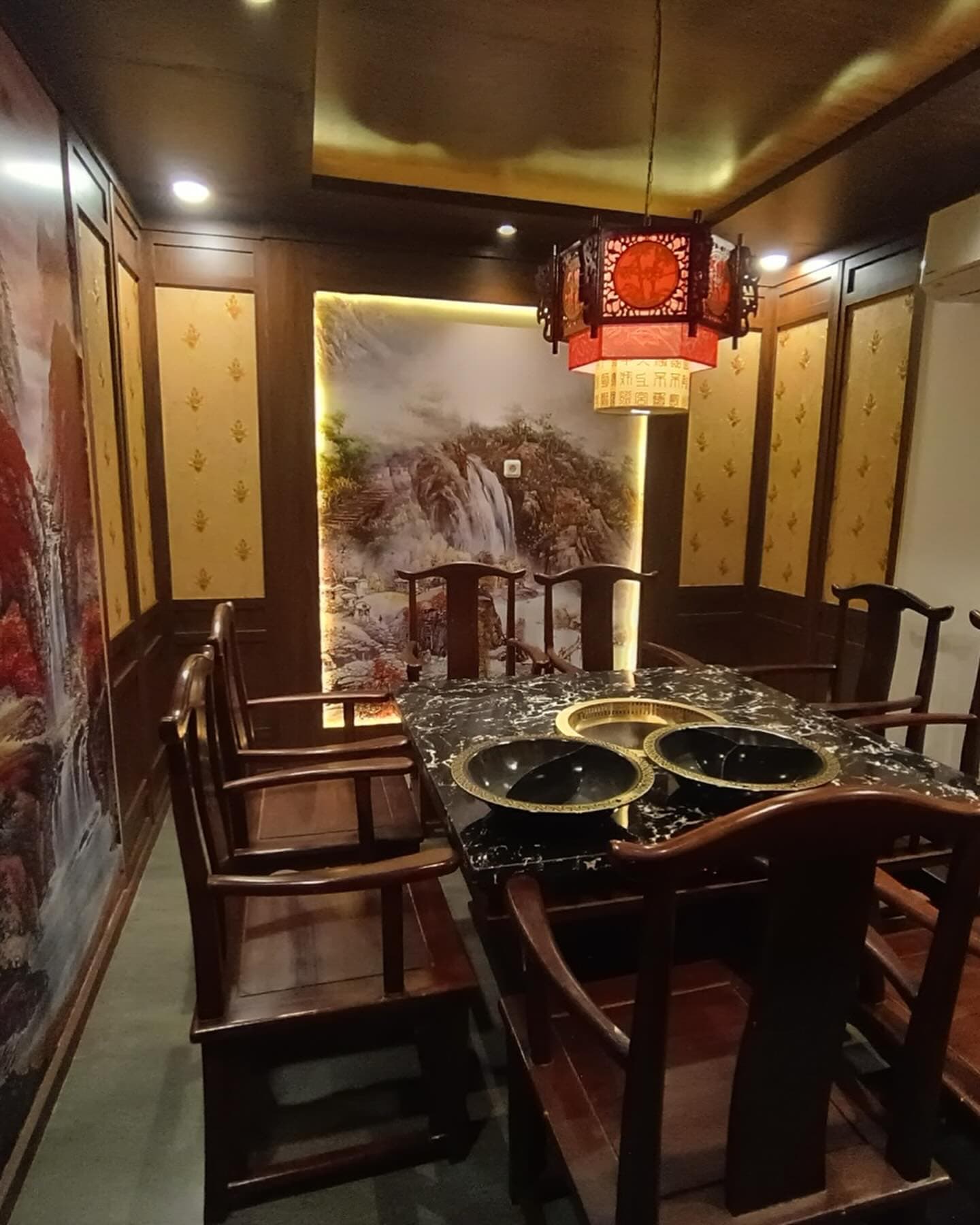 Finished dining room with a marble table and a red lantern