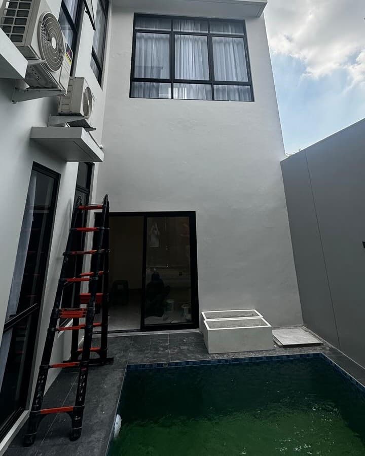 House under renovation in Tangerang, pool and scaffolding visible on site