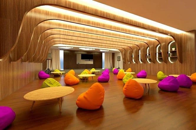 Auditorium render with a wood-slat ceiling and colourful bean bags