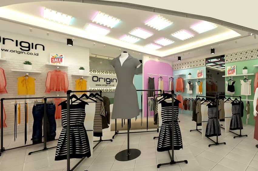 Clothing store interior with racks, display tables, and brick walls